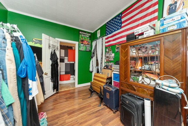 interior space featuring ornamental molding and wood finished floors