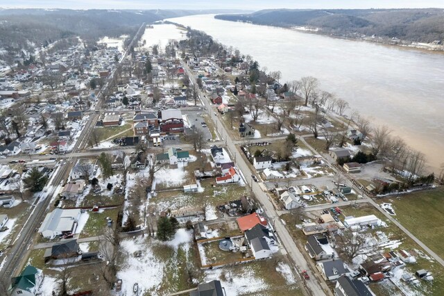 snowy aerial view with a residential view and a water view