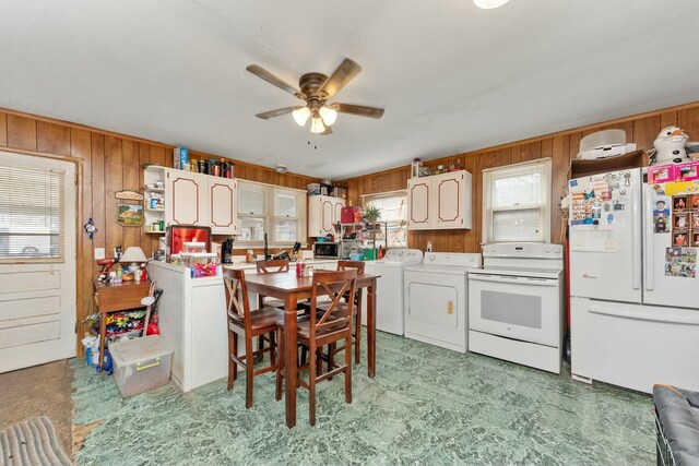 kitchen featuring light floors, open shelves, wood walls, ceiling fan, and white appliances