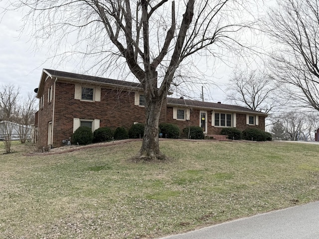 view of front of property with a front lawn and brick siding