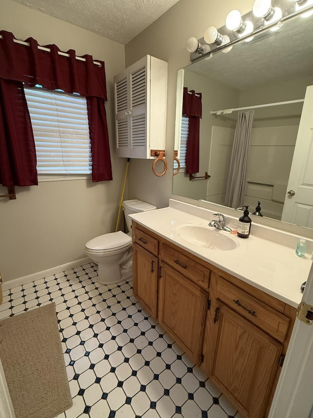 bathroom with a shower with shower curtain, toilet, tile patterned floors, a textured ceiling, and vanity