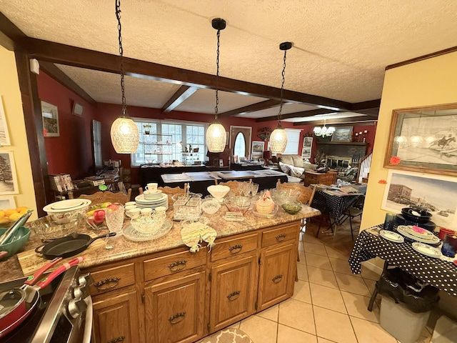 kitchen with brown cabinetry, stainless steel electric stove, open floor plan, and decorative light fixtures