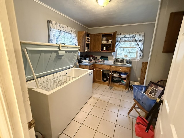 kitchen featuring open shelves, light tile patterned flooring, brown cabinets, and crown molding