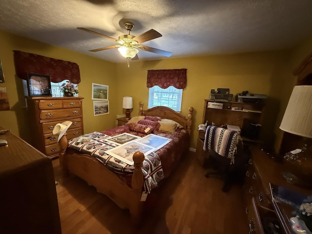 bedroom with a textured ceiling, ceiling fan, and wood finished floors