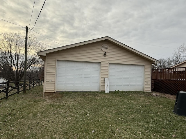 detached garage featuring fence