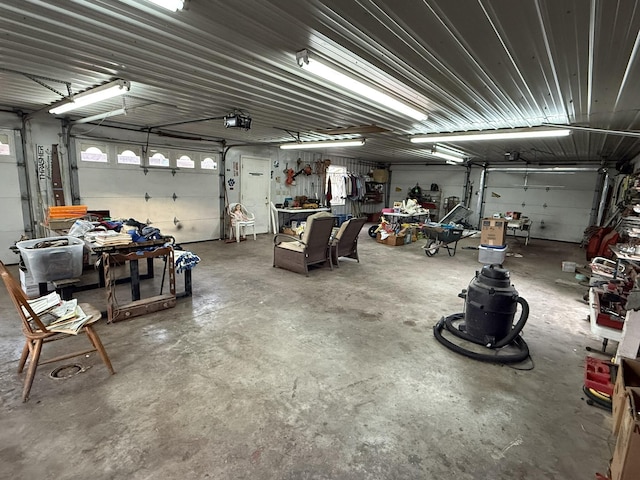 garage with a workshop area and a garage door opener