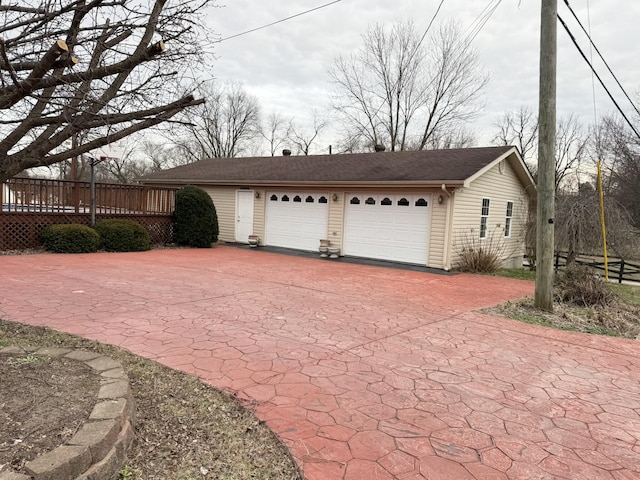 exterior space featuring a garage and a wooden deck