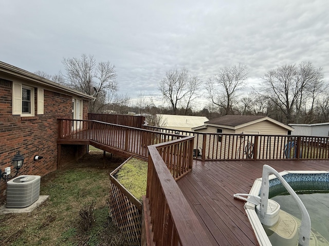 wooden terrace with central AC and an outdoor structure