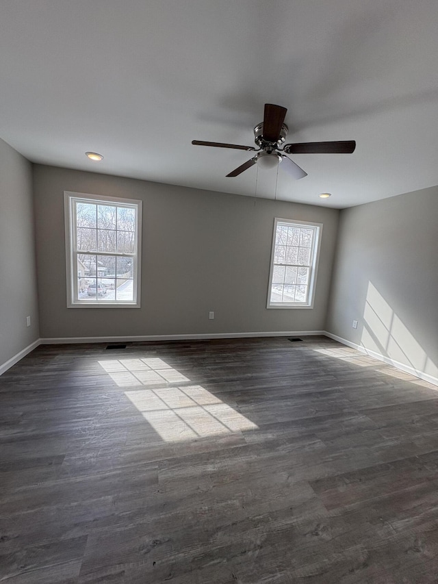 unfurnished room with recessed lighting, dark wood finished floors, baseboards, and ceiling fan