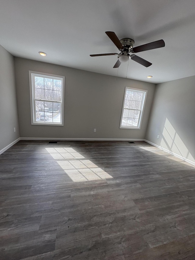 spare room featuring visible vents, baseboards, a ceiling fan, dark wood-style flooring, and recessed lighting