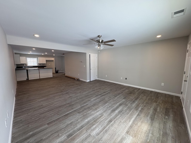 unfurnished living room with visible vents, dark wood finished floors, baseboards, and ceiling fan