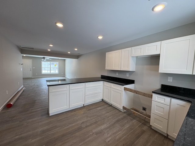 kitchen with recessed lighting, white cabinetry, open floor plan, dark wood-style floors, and dark countertops