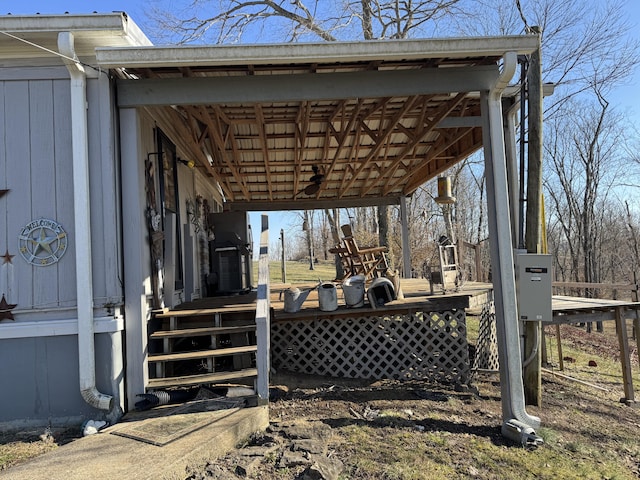 wooden terrace featuring a carport