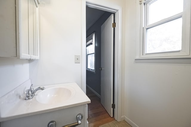 bathroom featuring baseboards and vanity