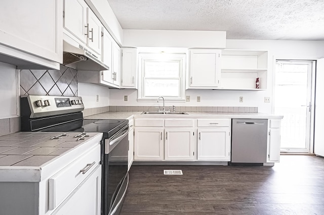 kitchen with stainless steel appliances, dark wood-type flooring, a sink, white cabinets, and open shelves