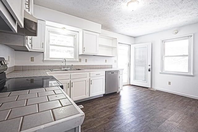 kitchen with dark wood-style floors, tile counters, white cabinetry, a sink, and dishwasher