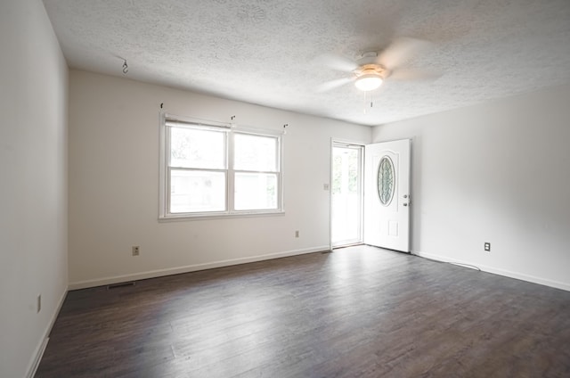 entrance foyer featuring dark wood-style floors, ceiling fan, baseboards, and a textured ceiling