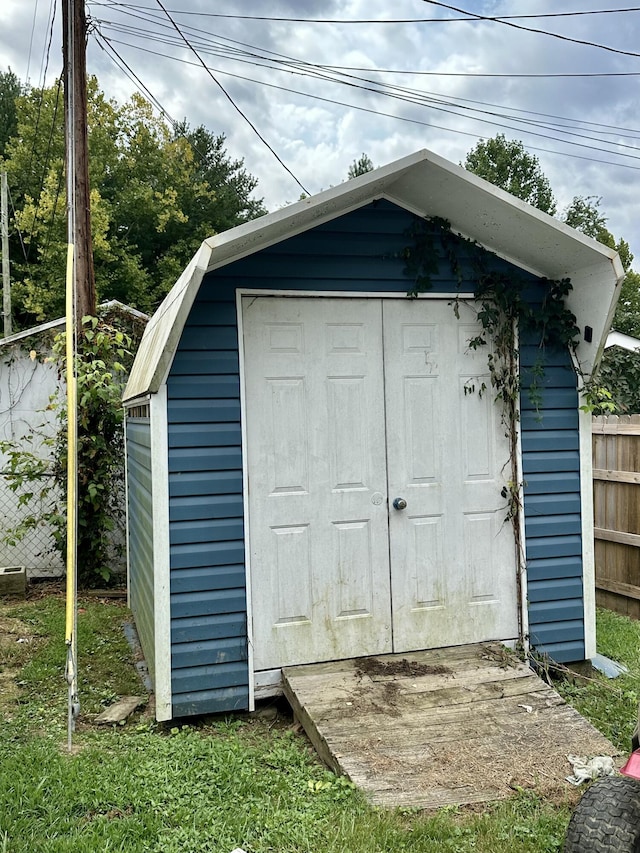 view of shed with fence