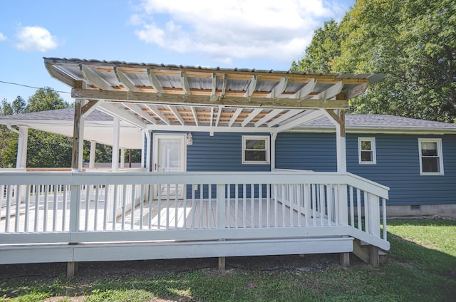 back of house with crawl space, roof with shingles, and a wooden deck