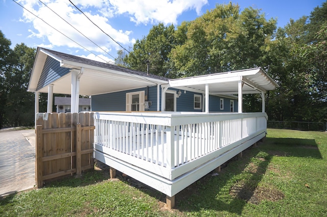 view of home's exterior featuring a deck and a lawn