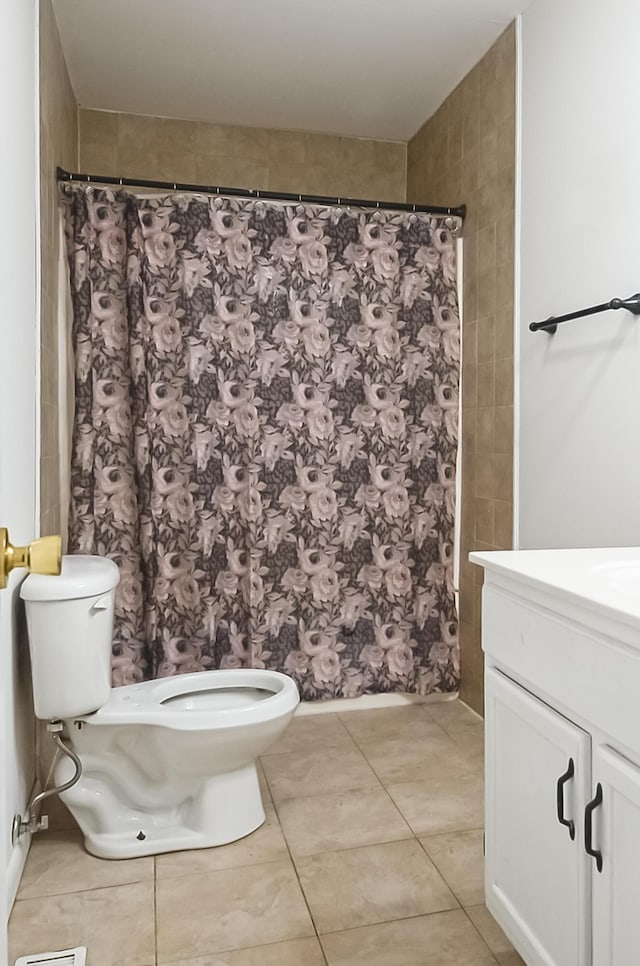 full bath with a shower with shower curtain, vanity, toilet, and tile patterned floors