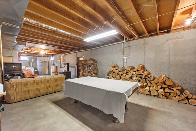 below grade area featuring water heater and pool table