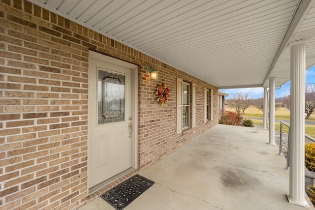 property entrance with brick siding