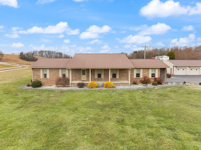 ranch-style home featuring driveway, brick siding, a front lawn, and a porch