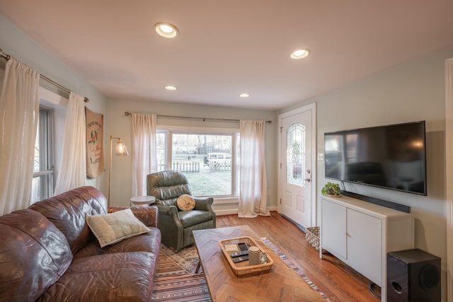 living room with light wood-style floors and recessed lighting