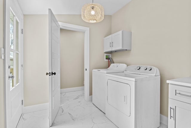 laundry area featuring marble finish floor, baseboards, cabinet space, and independent washer and dryer