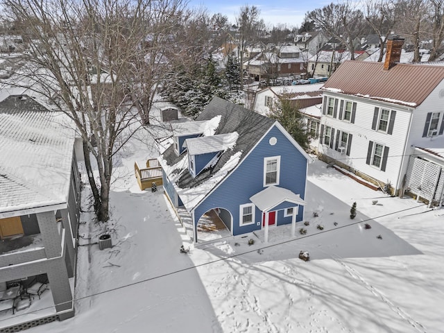 snowy aerial view featuring a residential view