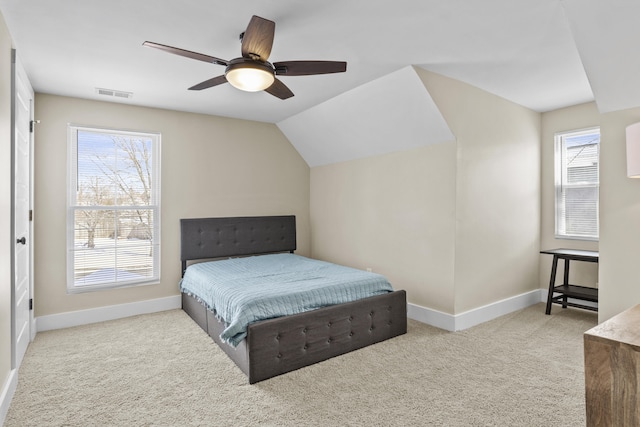 bedroom featuring baseboards, multiple windows, visible vents, and light colored carpet