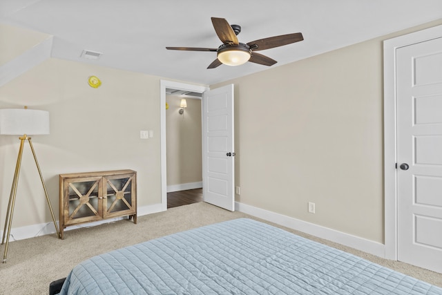 bedroom with visible vents, baseboards, a ceiling fan, and light colored carpet