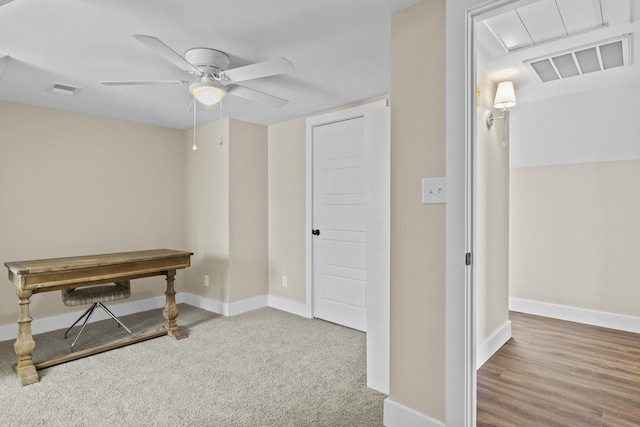 carpeted office featuring ceiling fan, visible vents, and baseboards