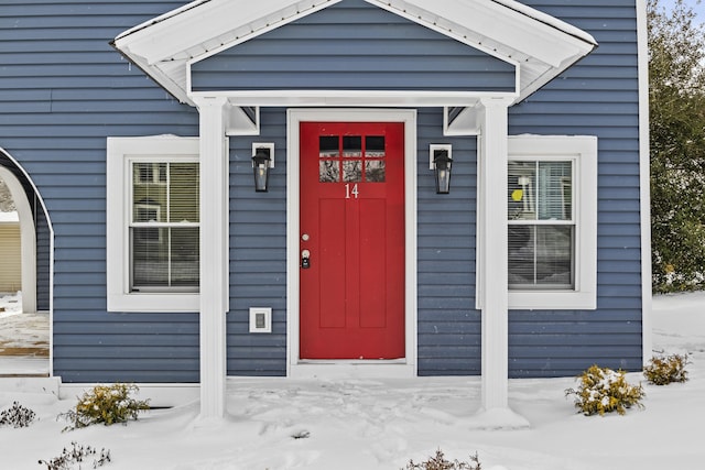 view of snow covered property entrance