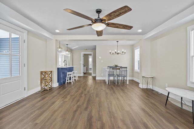 interior space featuring dark wood-style floors, a sink, baseboards, and an inviting chandelier