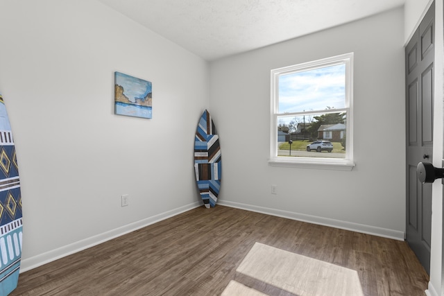 unfurnished bedroom featuring baseboards and wood finished floors