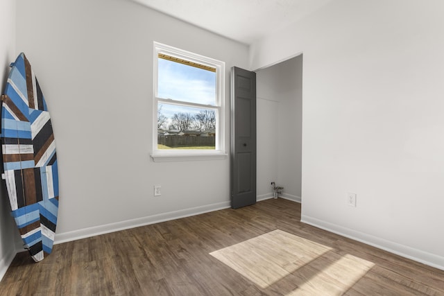 unfurnished bedroom featuring baseboards and wood finished floors