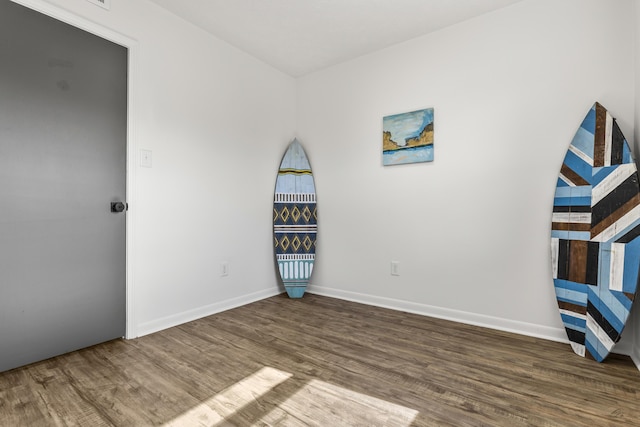 interior space featuring wood finished floors and baseboards