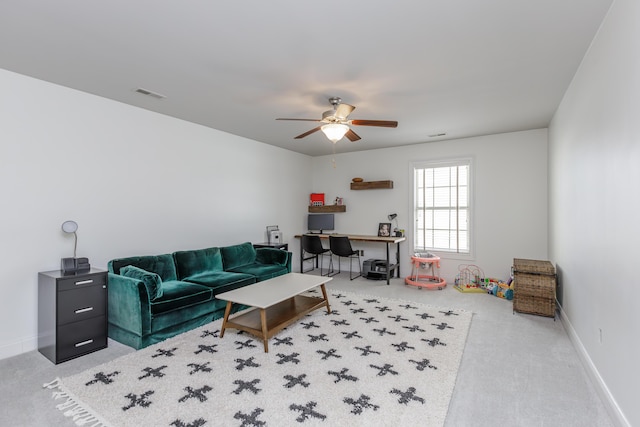 living room with baseboards, carpet, visible vents, and a ceiling fan