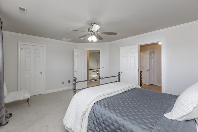 bedroom with visible vents, crown molding, light carpet, and baseboards