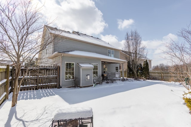 snow covered property featuring fence