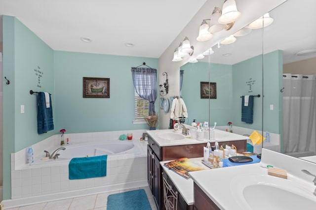 bathroom featuring a garden tub, tile patterned flooring, and vanity