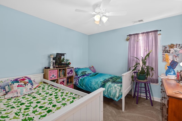 bedroom with a ceiling fan, visible vents, and light colored carpet