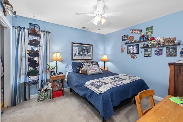 carpeted bedroom with ceiling fan, visible vents, and baseboards