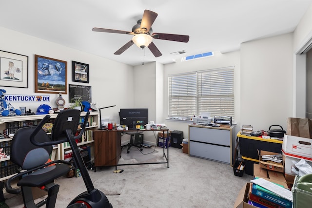 carpeted home office featuring ceiling fan and visible vents