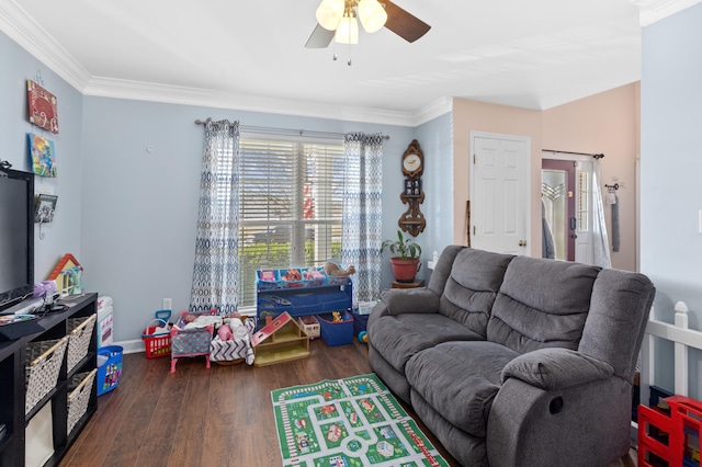 living area with a ceiling fan, crown molding, and wood finished floors