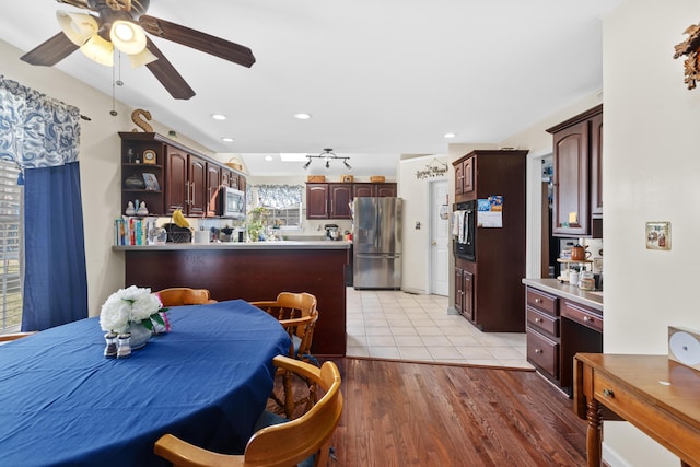 kitchen with a peninsula, stainless steel appliances, light wood-style floors, open shelves, and recessed lighting