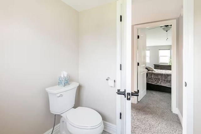 bathroom with toilet and baseboards