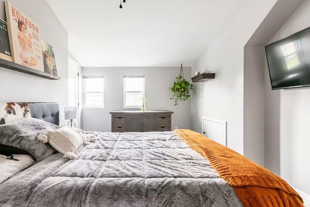 bedroom featuring vaulted ceiling, carpet, and baseboards